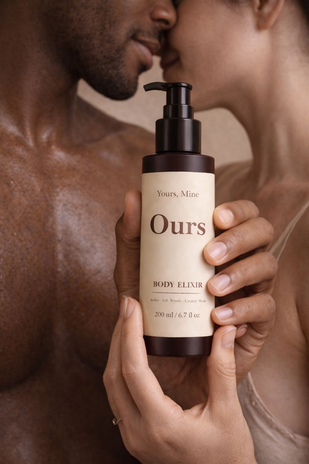 Person holding a bottle labeled 'Ours' with a blurred background